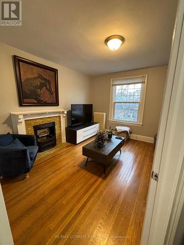 #2 - 79 Rosemount Avenue, Toronto, ON - Indoor Photo Showing Living Room With Fireplace