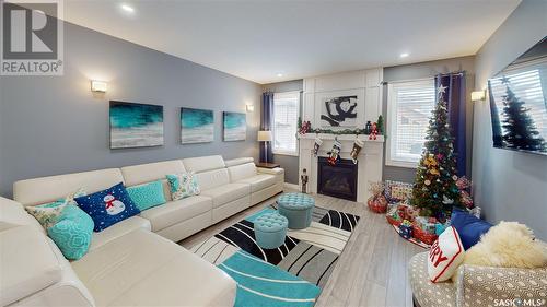 7033 Maple Fern Bay, Regina, SK - Indoor Photo Showing Living Room With Fireplace