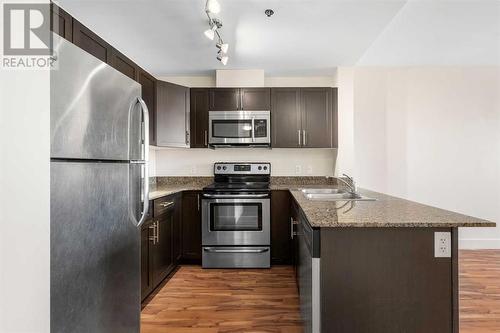 319, 955 Mcpherson Road Ne, Calgary, AB - Indoor Photo Showing Kitchen With Stainless Steel Kitchen With Double Sink With Upgraded Kitchen