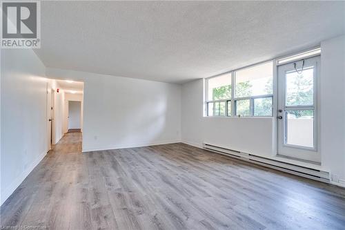 Living room with access to the balcony - 700 Dynes Road Unit# 109, Burlington, ON - Indoor Photo Showing Other Room