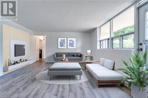 Virtually staged living room - 700 Dynes Road Unit# 109, Burlington, ON - Indoor Photo Showing Living Room