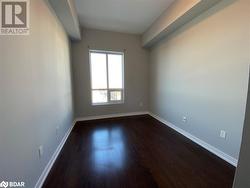 Empty room featuring dark wood-type flooring - 