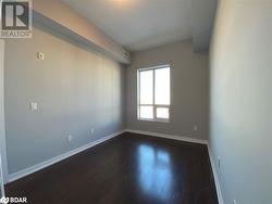 Empty room featuring dark wood-type flooring - 