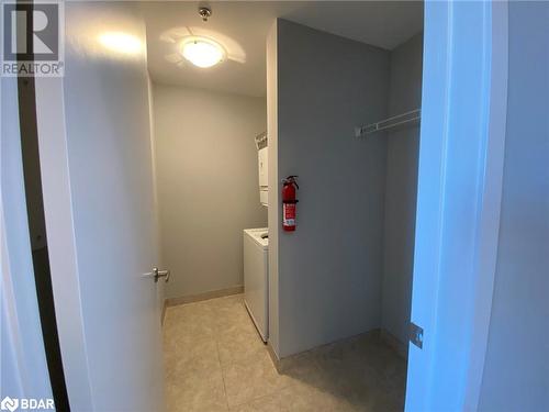 Washroom with washing machine and dryer and light tile patterned flooring - 2486 Old Bronte Road Unit# 813, Oakville, ON 