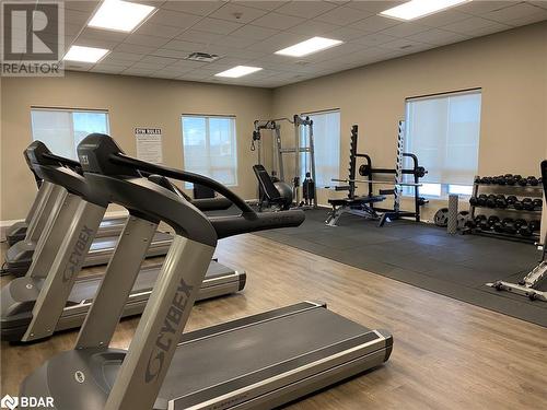 Gym with hardwood / wood-style floors, a paneled ceiling, and a healthy amount of sunlight - 2486 Old Bronte Road Unit# 813, Oakville, ON 