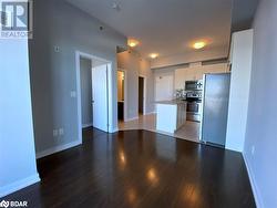 Kitchen featuring decorative backsplash, appliances with stainless steel finishes, dark hardwood / wood-style floors, and a kitchen island - 