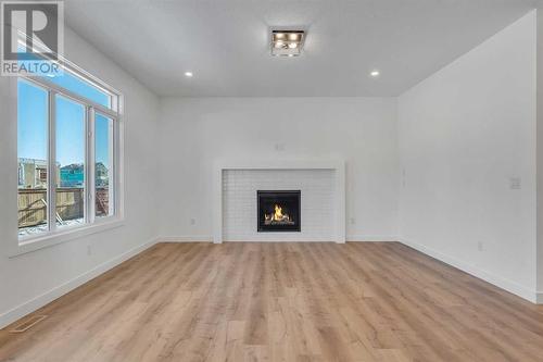 239 Kinniburgh Loop, Chestermere, AB - Indoor Photo Showing Living Room With Fireplace