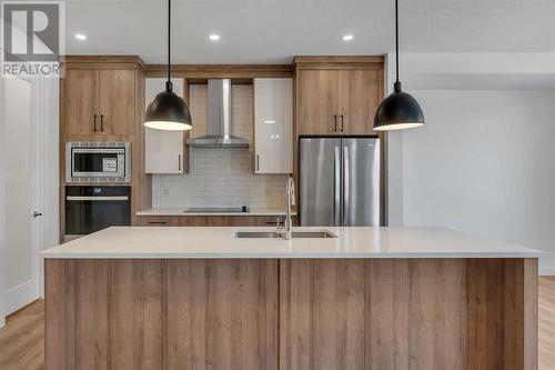 239 Kinniburgh Loop, Chestermere, AB - Indoor Photo Showing Kitchen With Stainless Steel Kitchen With Double Sink With Upgraded Kitchen