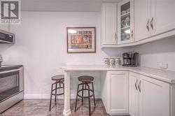 Kitchen featuring light stone countertops, white cabinets, and appliances with stainless steel finishes - 