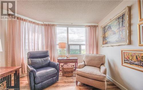 Living area featuring hardwood / wood-style floors and a textured ceiling - 55 Green Valley Drive Drive Unit# 1806, Kitchener, ON - Indoor Photo Showing Other Room