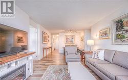 Living room featuring light hardwood / wood-style floors and a textured ceiling - 