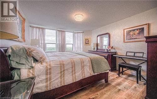 Bedroom with a textured ceiling and light hardwood / wood-style flooring - 55 Green Valley Drive Drive Unit# 1806, Kitchener, ON - Indoor Photo Showing Bedroom