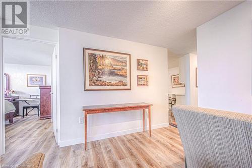 Hall with light hardwood / wood-style floors and a textured ceiling - 55 Green Valley Drive Drive Unit# 1806, Kitchener, ON - Indoor