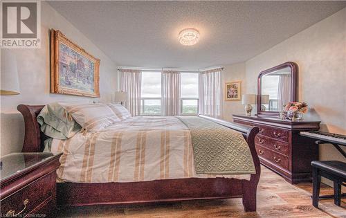 Bedroom with a textured ceiling and light hardwood / wood-style flooring - 55 Green Valley Drive Drive Unit# 1806, Kitchener, ON - Indoor Photo Showing Bedroom