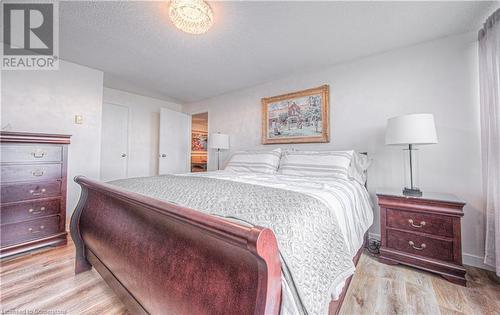 Bedroom with a textured ceiling and light hardwood / wood-style flooring - 55 Green Valley Drive Drive Unit# 1806, Kitchener, ON - Indoor Photo Showing Bedroom