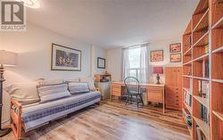 Home office with a textured ceiling and hardwood / wood-style flooring - 