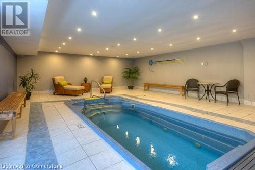 View of swimming pool with a hot tub - 55 Green Valley Drive Drive Unit# 1806, Kitchener, ON - Indoor Photo Showing Other Room With In Ground Pool