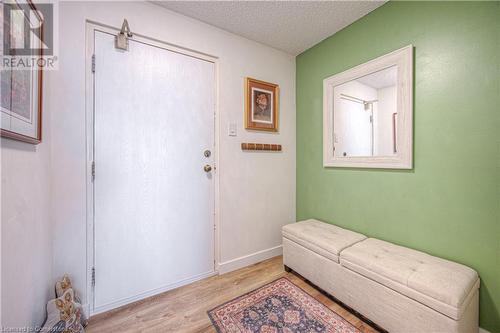 Foyer entrance featuring a textured ceiling and light wood-type flooring - 55 Green Valley Drive Drive Unit# 1806, Kitchener, ON - Indoor Photo Showing Other Room