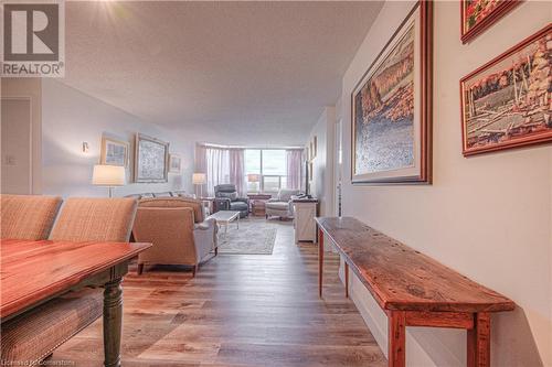 Living room with wood-type flooring and a textured ceiling - 55 Green Valley Drive Drive Unit# 1806, Kitchener, ON - Indoor