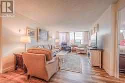 Living room featuring light hardwood / wood-style flooring and a textured ceiling - 