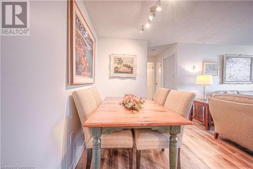 Dining area featuring a textured ceiling and light hardwood / wood-style flooring - 55 Green Valley Drive Drive Unit# 1806, Kitchener, ON - Indoor Photo Showing Dining Room