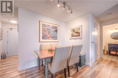 Dining space with a textured ceiling and light wood-type flooring - 55 Green Valley Drive Drive Unit# 1806, Kitchener, ON - Indoor Photo Showing Dining Room