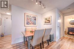 Dining space with a textured ceiling and light wood-type flooring - 