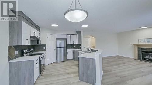 246 Saddlefield Place Ne, Calgary, AB - Indoor Photo Showing Kitchen With Fireplace