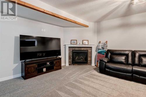 45 Mackenzie Way, Carstairs, AB - Indoor Photo Showing Living Room With Fireplace