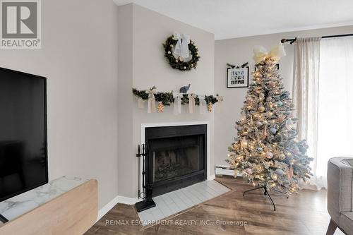 134 - 1496 Pilgrims Way, Oakville, ON - Indoor Photo Showing Living Room With Fireplace