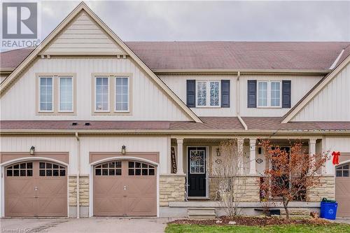 Craftsman-style home with a front yard and a garage - 74 Shallow Creek Road, Woolwich, ON - Outdoor With Facade