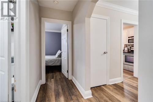 Hall with dark hardwood / wood-style floors and ornamental molding - 245 St Andrews Street, Cambridge, ON - Indoor Photo Showing Other Room