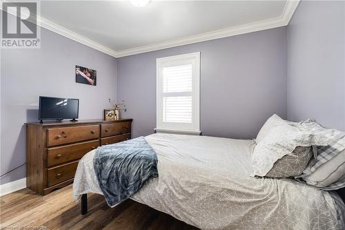 Bedroom featuring wood-type flooring and ornamental molding - 245 St Andrews Street, Cambridge, ON - Indoor Photo Showing Bedroom