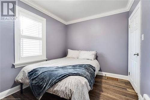 Bedroom with dark hardwood / wood-style floors and ornamental molding - 245 St Andrews Street, Cambridge, ON - Indoor Photo Showing Bedroom