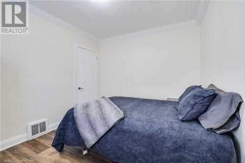 Bedroom featuring wood-type flooring and ornamental molding - 245 St Andrews Street, Cambridge, ON - Indoor Photo Showing Bedroom