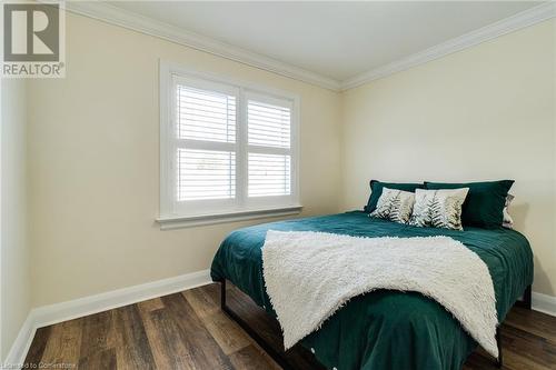 Bedroom featuring dark hardwood / wood-style flooring and ornamental molding - 245 St Andrews Street, Cambridge, ON - Indoor Photo Showing Bedroom