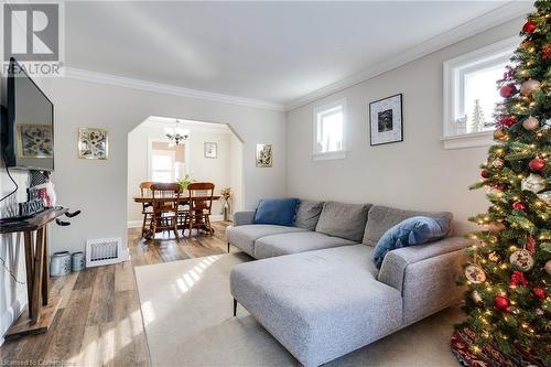 Living room featuring ornamental molding, a notable chandelier, and hardwood / wood-style flooring - 245 St Andrews Street, Cambridge, ON - Indoor Photo Showing Living Room