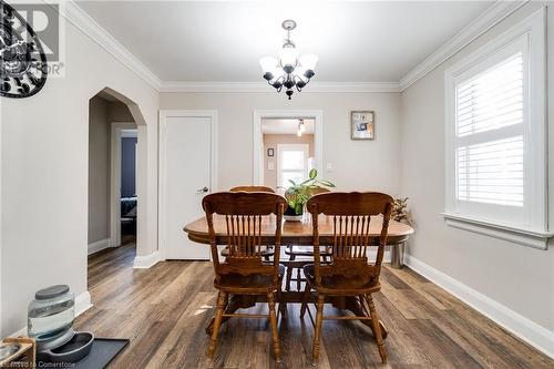 Dining room featuring dark hardwood / wood-style floors, crown molding, and an inviting chandelier - 245 St Andrews Street, Cambridge, ON - Indoor Photo Showing Dining Room