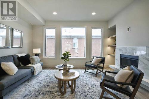 2222 5 Street Sw, Calgary, AB - Indoor Photo Showing Living Room With Fireplace