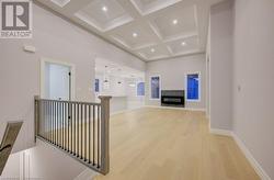 Hallway with beamed ceiling, light hardwood / wood-style floors, and coffered ceiling - 