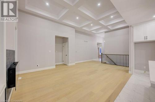 Living room featuring beam ceiling, light wood-type flooring, and coffered ceiling - 705 Hollinger Drive S, Listowel, ON - Indoor Photo Showing Other Room