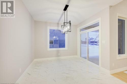 Unfurnished dining area featuring a notable chandelier - 705 Hollinger Drive S, Listowel, ON - Indoor Photo Showing Other Room