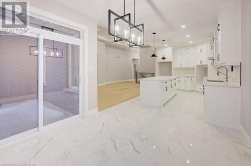 Kitchen featuring pendant lighting, a center island, white cabinetry, and sink - 705 Hollinger Drive S, Listowel, ON - Indoor