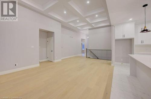 Unfurnished room with beam ceiling, light hardwood / wood-style flooring, and coffered ceiling - 705 Hollinger Drive S, Listowel, ON - Indoor Photo Showing Other Room