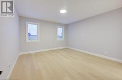 Spare room featuring light wood-type flooring - 