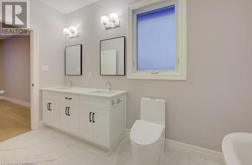 Bathroom with vanity, a tub to relax in, and toilet - 705 Hollinger Drive S, Listowel, ON - Indoor Photo Showing Bathroom