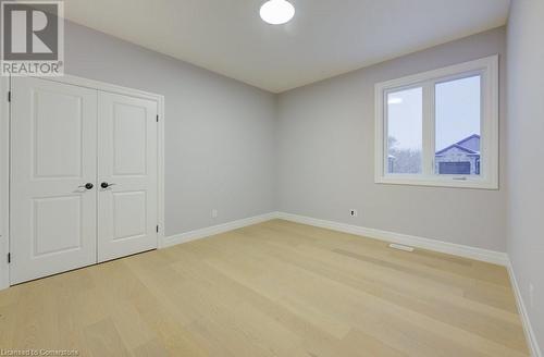 Unfurnished bedroom featuring a closet and light hardwood / wood-style floors - 705 Hollinger Drive S, Listowel, ON - Indoor Photo Showing Other Room