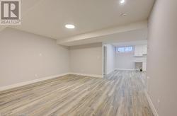 Basement featuring light wood-type flooring - 