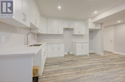 Kitchen featuring white cabinets, light wood-type flooring, and sink - 705 Hollinger Drive S, Listowel, ON - Indoor Photo Showing Kitchen