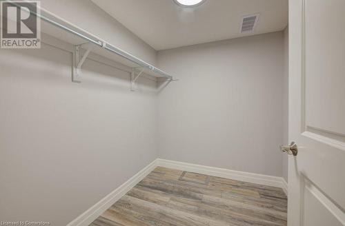 Walk in closet featuring light hardwood / wood-style flooring - 705 Hollinger Drive S, Listowel, ON - Indoor With Storage